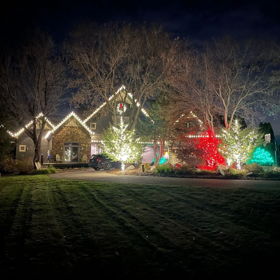 Holiday lighting installation — multi-color roofline and landscape accents